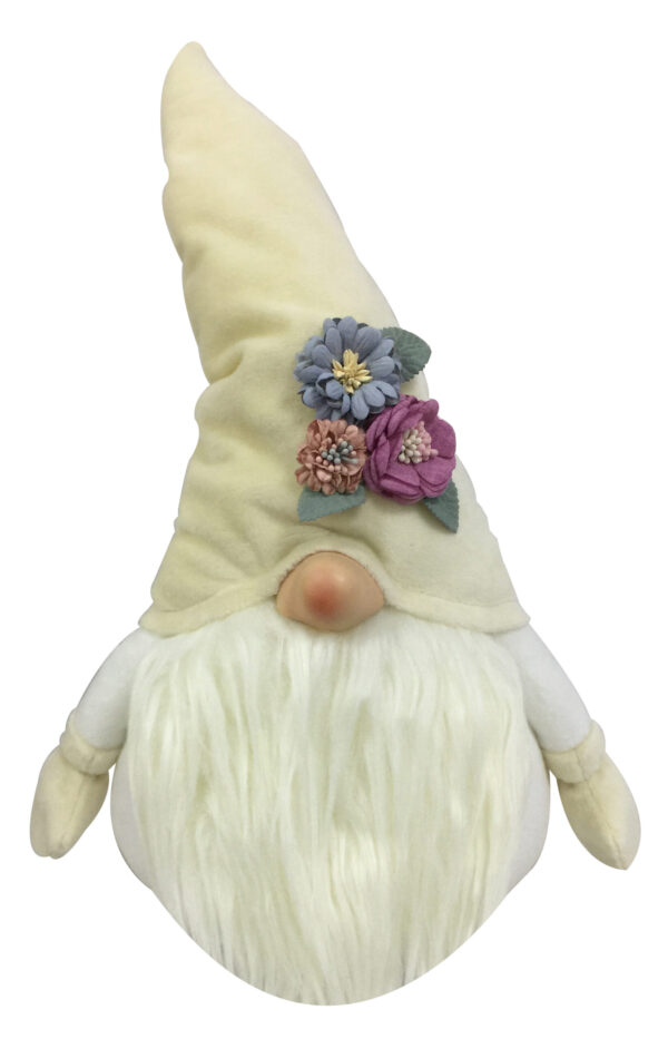 A cream coloured Christmas Gonk with flowers. The body of this gonk is white with cream coloured mittens at the end of each arm. It has a fluffy cream coloured beard which sits beneath its pink nose. On it's head it has a pointy cream hat that has a small posy of blue, purple and pink flowers with green leaves that sits above the nose on the left hand side.