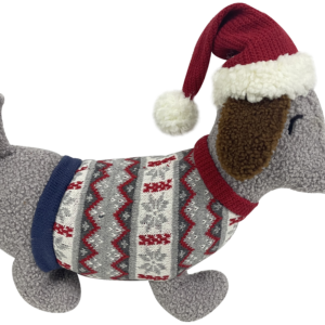 A Grey Bouclé Fabric Sausage Dog Doorstop. The main body of the dachshund shaped doorstep is made of grey bouclé fabric. He has a grey, red, white and navy Nordic style jumper on. His ears are made of brown bouclé fabric. He has a round black nose and eyes. On his head he is wearing a red knitted Santa hat with white fur trim and matching pompom.