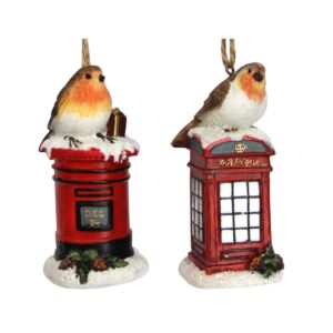 A pair of iconic British Christmas decorations. The decoration on the left depicts a classic British post box. It s round and red with the last post dated as 'DEC 24'. It sits in a mound of iridescent glittery snow decorated with some festive foliage. On top of the snowy covered post box sits a Robin with a wrapped gift. The decoration on the right depicts a classic British telephone box. It is square and red with white windows and the word 'Telephone' across the top in gold. It sits in a mound of iridescent glittery snow decorated with some festive foliage. On top of the snowy covered telephone box sits a Robin.