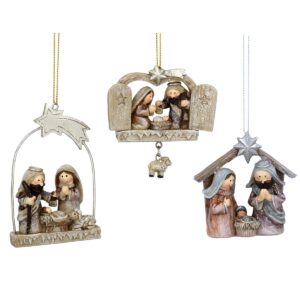 Set of three Cristmas tree decorations depiting the Nativity Scene. On the left is the ARCHWAY - This resin nativity scene (7cm) shows the beige and pastel figures of Mary and Joseph praying over the child as they stand under an arch and a shining shooting star - the decoration is then sprinkled with a light dusting of silver glitter, for added festive sparkle. In the centre is the DOUBLE DOORS  - This adorable glittering resin decoration shows the classic Nativty scene behind two star-etched aged stable doors, complete with the shining silver North Star and a sweet little sheep figure that hangs gracefully from the base of the decoration. And on the right is the MANGER  - This decoration is a very classic depiction of the Nativity story, with the pastel-coloured figures of Mary and Joseph praying over their new child in the wooden stable as the brilliant silver star shines brightly above.