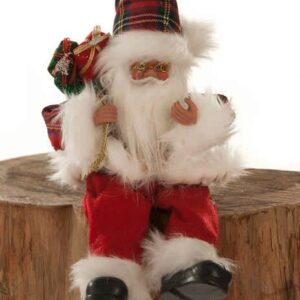 A traditonal Santa figurine sitting on a log. Santa has a jollyy face that is peeking out from behind his fluffy white beard. He is wearing a red tartan jacket with white fur trim and cuffs and matching Santa hat. He has red trousers that also have a white fur cuff and black boots, Over his right shoulder he is carrying a sack of festive gifts. He is sitting on a log with his legs hanging over the edge.