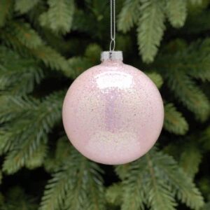 A clear glass Christmas tree bauble filled with iridescent sparkly pink glitter. Hanging from a silver string.