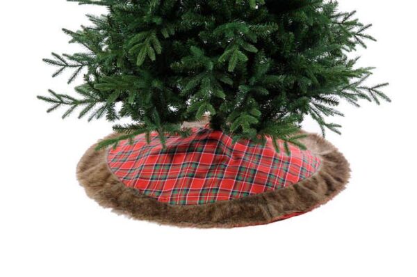 A red tartan fabric Christmas tree skirt with brown fur trim beneath a gren Christmas tree.