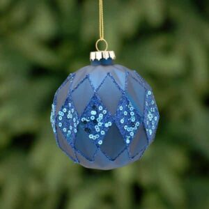 A matt navy, geometric round shaped, glass Christmas tree bauble decorated with fine lines of blue glitter and blue glitter and sequin diamond shaped panels.