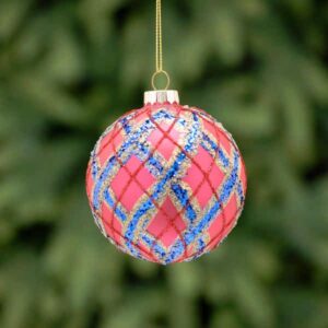 A matt red, glass Christmas tree bauble decorated with fine lines of blue, gold and red glitter that creates a tartan pattern on the bauble.