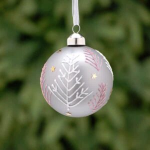 A matt grey, glass Christmas tree bauble decorated with pale pink and white Christmas tree patterns made from fine lines of glitter adorned with gold stars.