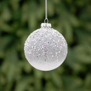 A silver frosted, glass Christmas tree bauble decorated in fine silver glitter that creates an ombre effect and finished with triangular silver sequins across the top half.