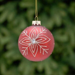 An antique red, glass Christmas tree bauble decorated with fine silver glitter lines in a floral snowflake pattern with a white diamante jewel in the centre.