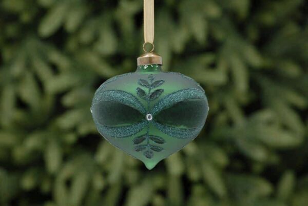 A matt green onion shaped glass Christmas tree bauble decorated with a leaf and bow pattern in dark green flock and green glitter with a white diamante jewel in the centre.