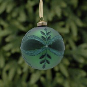 A matt green glass Christmas tree bauble decorated with a leaf and bow pattern in dark green flock and green glitter with a white diamante jewel in the centre.