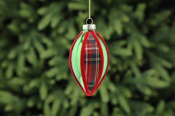 A metallic green teardrop shaped glass Christmas tree bauble with red tartan fabric segments and finished with red velour ribbon around the segments.