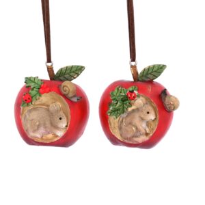 Two ployresin Christmas tree decorations depicting red apples with brown mice living inside them. The apple on the left has a sprig of holly decorating it and a small brown mouse and snail living on it. The apple on theright is decorated witha sprig of ivy and a small brown mouse and snail living on it. Both hang from brown suede strings.