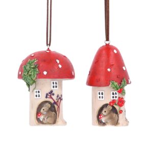 Two ployresin Christmas tree decorations depicting red toadstools with brown mice living inside them. The toadstool on the left has a domed shaped top and a sprig of ivy decorating it and a small brown mouse living inside it. It has a blueberry bush outside. The toadstool on the right has a pointed top and is decorated with a sprig of holly and a small brown mouse living inside it. It has a rosehip bush outside. Both hang from brown suede strings