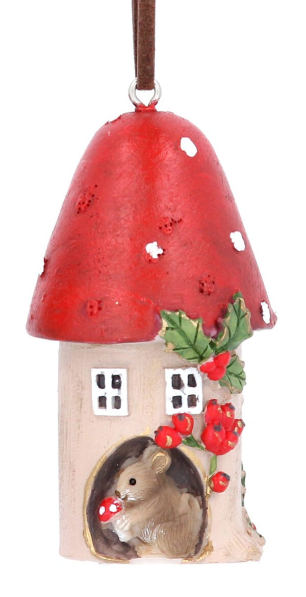 A ployresin Christmas tree decorations depicting a red toadstool with a brown mouse living inside it. The toadstool t has a pointed top and is decorated with a sprig of holly and a small brown mouse living inside it. It has a rosehip bush outside It hangs from brown suede string.