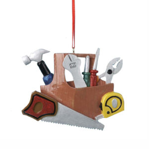 A colourful polyresin Christmas tree decoration depicting a Helpful Handyman's Toolkit. A wooden box holds a hammer. a wrench, two screwdrivers and a a pair of pliers. Outside the box sits a measuring tape and a saw.