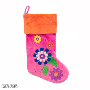 A Hot Pink Velvet Floral Stocking with colourful appliqued flowers on the main body. The flowers are blue, yellow, pink, purple and orange in colour and are connected to one another by green appliqued leaves and embroidered vines. The cuff of the stocking is orange velour and has a hot pink velour loop for hanging.