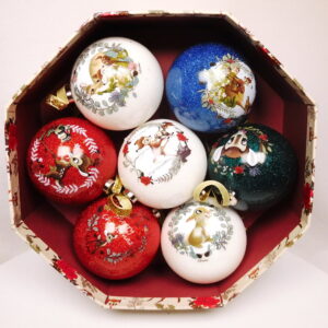 An octangonal shaped cardboard gift box filled with a set of seven Christmas tree baubles decorated with images from Disney's Bambi.