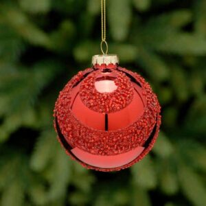 A metallic red, glass Christmas tree bauble decorated with alternating swags of tiny red beads all over. Hanging from a gold string.