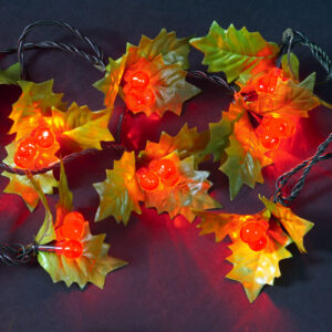 An illuminated string of 100 LED Red Berry lights with green fabric holly leaves.