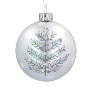 A matt white, glass Christmas tree bauble decorated on one side with a pale sage green Christmas tree with purple, lilac and white leaves and berries surrounded be white snowflakes.