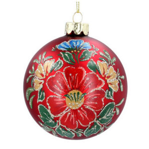 A matt red, glass Christmas tree bauble decorated with a red flower with a yellow centre surrounded by yellow and blue flowers and green foliage with silver glitter detail on the petals and leaves.