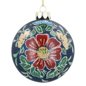 A dark blue, glass Christmas tree bauble decorated with a red flower with a yellow centre surrounded by yellow and blue flowers and green foliage with silver glitter detail on the petals and leaves.