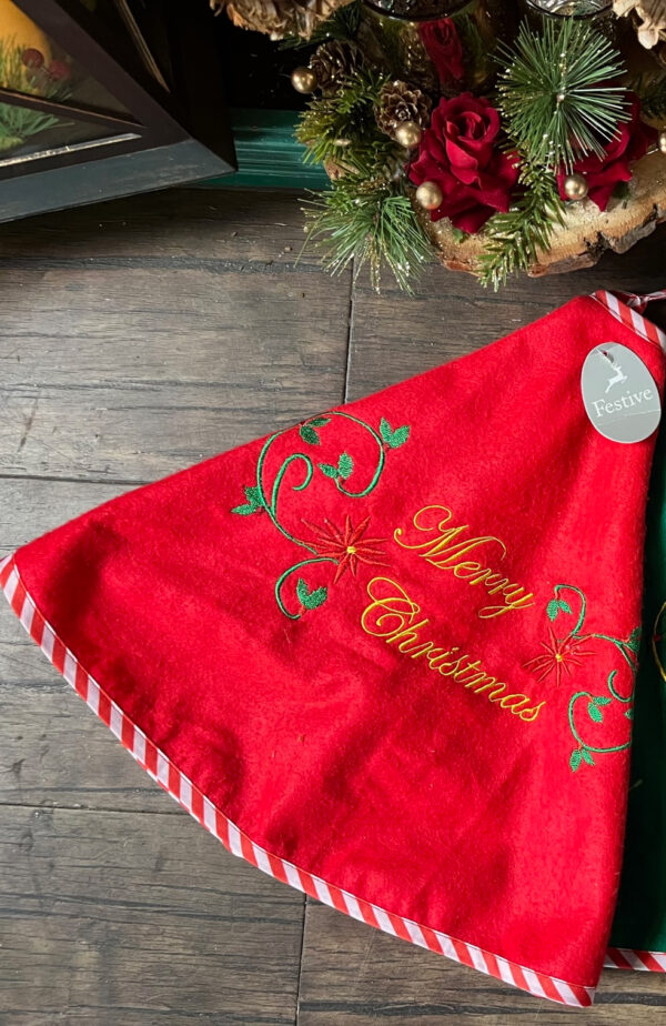 80cm Embroidered Red Felt Tree Skirt with a decorative Merry Christmas message, in gold, a decorative swirl in green & holly and starburst embroidery. Trimmed with red and white candy cane style fabric.