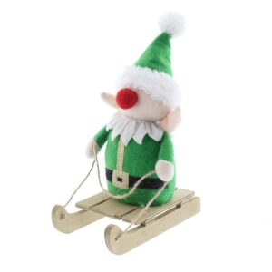 A plush Elf figurine with a green fabric suit and matching hat with a white fluffy trim. he has pointy elf ears and a red nose and is sitting upon a wooden sleigh.