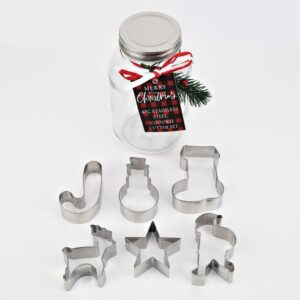 A set of six metal cookie cutters in different Christmas shapes. There's a Candy Cane, Snowman, Stocking, Reindeer, Star and Santa. They come in a clear Mason jar with a silver lid that is decorated with a festive sprig and red and white ribbon.