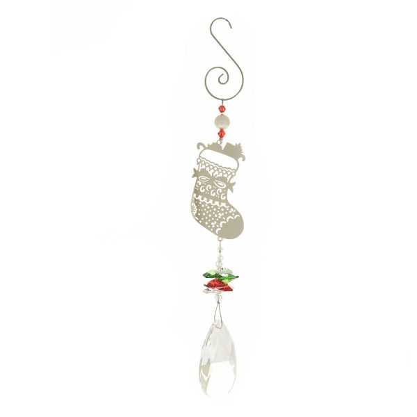 Crystal Suncatcher Window Decoration - Christmas Stocking Design. This suncatcher has a large faceted crystal at the bottom of its pendulum, held beneath a cluster of smaller green, red and white crystals. They hang beneath a Christmas Stocking motif made of fine filigree metal. This is attached to the hanging hook at the top by some festive beads. Shown against a white background