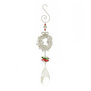 Crystal Suncatcher Window Decoration - Christmas Wreath Design. This suncatcher has a large faceted crystal at the bottom of its pendulum, held beneath a cluster of smaller green, red and white crystals. They hang beneath a Christmas Wreath motif made of fine filigree metal. This is attached to the hanging hook at the top by some festive beads. Shown against a white background