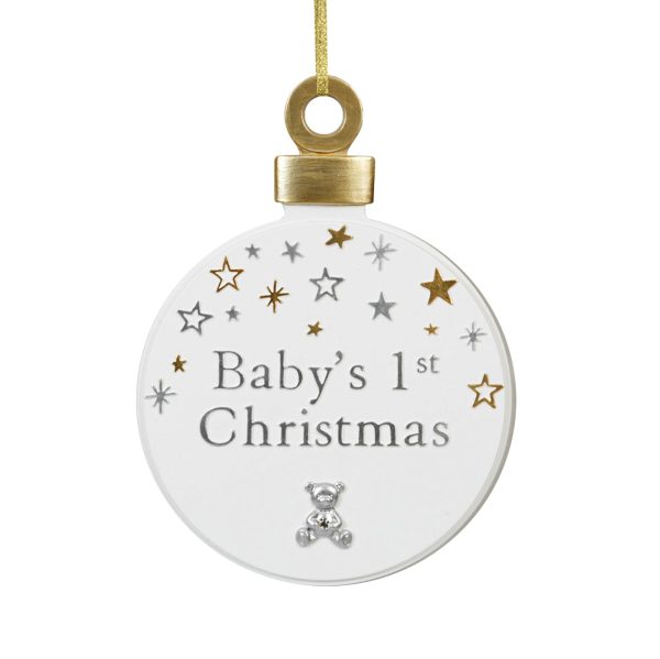 This image shows a flat (about 1cm thick) Baby's first Christmas hanging decoration. The diameter is about 10cm's. The decoration is in the shape of a Christmas bauble. The bauble has a gold topped hoop for tying the ribbon off. The bauble is white, withe a decoration of assorted stars along the top and down the top sides if the bauble. The stars ar gold & silver, are a mixture of solid and outline stars, and are a mixture of big and small. In the centre of the bauble, under the stars are the silver words 'Baby's 1st Christmas' over two lines and under the word Christmas is a silver teddy bear image holding a little sparkle diamonte style gem over his belly.