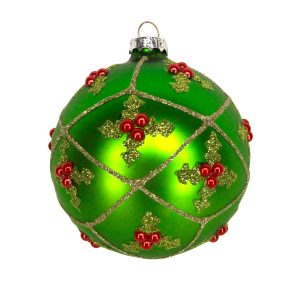 An 8cm glass Christmas Bauble by Gisela Graham. This bauble has a vibrant matt green surface decorated with green glitter holly leaves and red jewel berries, they are framed by a pale gold glitter lattice.