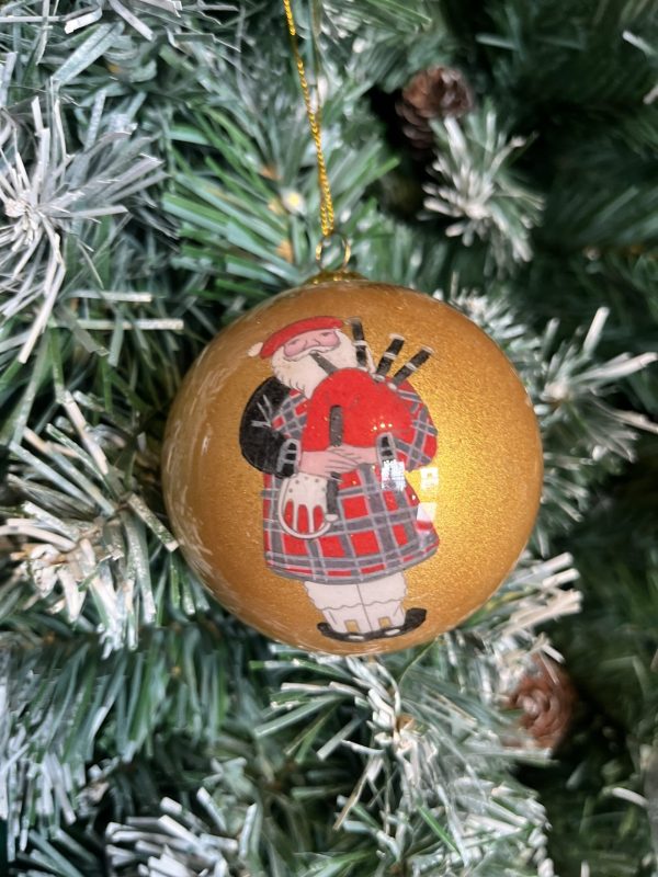 A Hand Painted Gold Scottish Santa Glass Christmas Bauble with Gift Box, featuring a scottish bagpiper design, all beautifully packaged in a gift box.