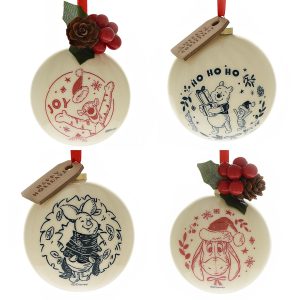 Disney's Wonderful Winnie The Pooh Boxed Baubles - Set of Four featuring illustrated characters: Tigger with "Joy," Winnie the Pooh with "Ho Ho Ho," Piglet in a wreath, and Eeyore in a Santa hat. Decorations include pine cones and berries.