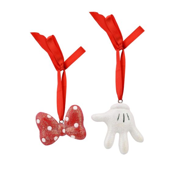 Two Christmas ornaments hanging from red ribbons: one is a red and white polka dot bow, the other is a white glove from the Disney Set of Two Minnie Mouse Bow & Glove Hanging Decorations.