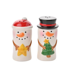 A pair of ceramic Santa and snowman-shaped salt and pepper shakers, one holding a star and the other holding a Christmas tree, both with smiling faces and festive decorations.