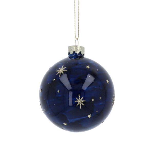 A dark blue glass Christmas ornament decorated with silver stars and dots and a crescent moon making the bauble look like a night sky, hanging by a delicate silver fastener and silver string.