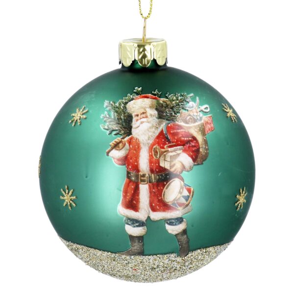 A charming Christmas ornament features Santa Claus carrying a sack of gifts, surrounded by delicate gold snowflakes and glitter accent on the bottom of the ornament