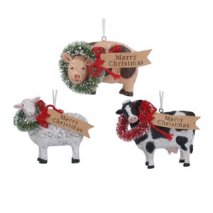 Three Christmas ornaments in the shape of a pig, sheep, and cow, each wearing a festive wreath and holding a "Merry Christmas" banner.