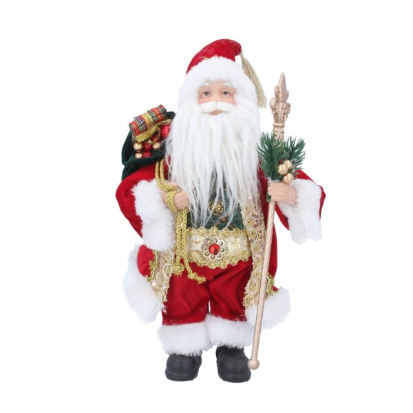 Nostalgic Father Christmas Standing Figurine. Santa wears a traditional red velour suit with white trim. His jacket is decorated with gold sequined lapels that sit over his green checked jumper. Around his waist he has a gold belt fastened with a large ruby jewel. His santa hat matches his jacket and is embellished with a gold tassel at the tip. In his left hand he is holding a gold staff decorated with green foliage and gold berries and over his right shoulder he is carrying a sack of wrapped gifts. On his cheery face he is wearing gold rimmed spectacles that compliment his big white fluffy beard.