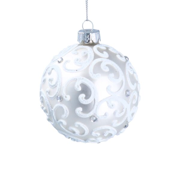 White Christmas ornament decorated with ornate swirl patterns and small silver accents, hanging on a thin silver string.